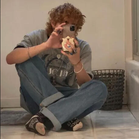 Collage consisting of different stationary elements on brown paper, including a red paper clip, a sticker of a bird silhouette, tape, and scissors. On it is the title of the zine: "Confidential: The Neil Josten Experience (Definitely Not Mafia Secreits).